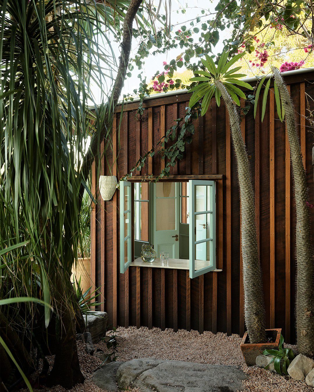 A cozy garden shed surrounded by lush greenery