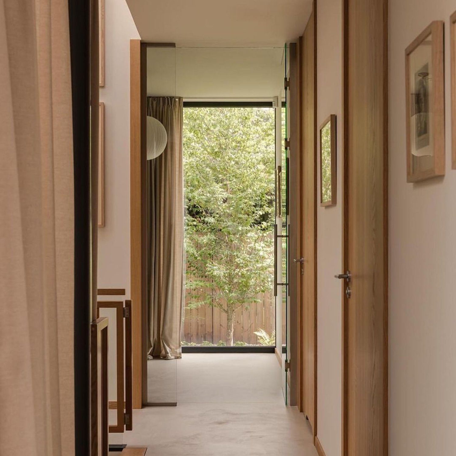 A serene hallway with a view to a lush garden