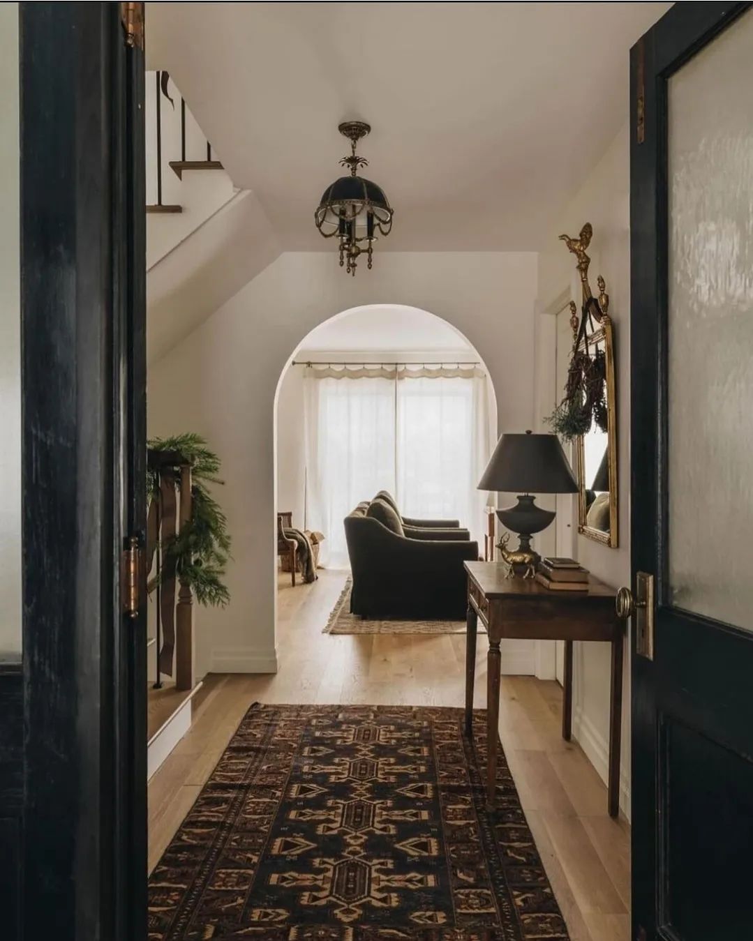 An inviting hallway with warm lighting and rich decor