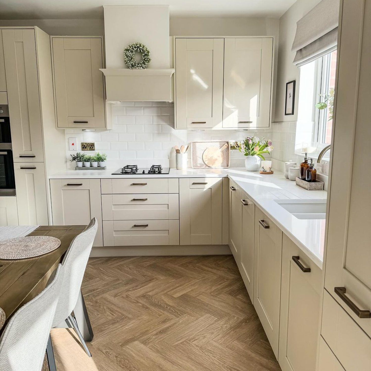 A modern kitchen design featuring herringbone flooring