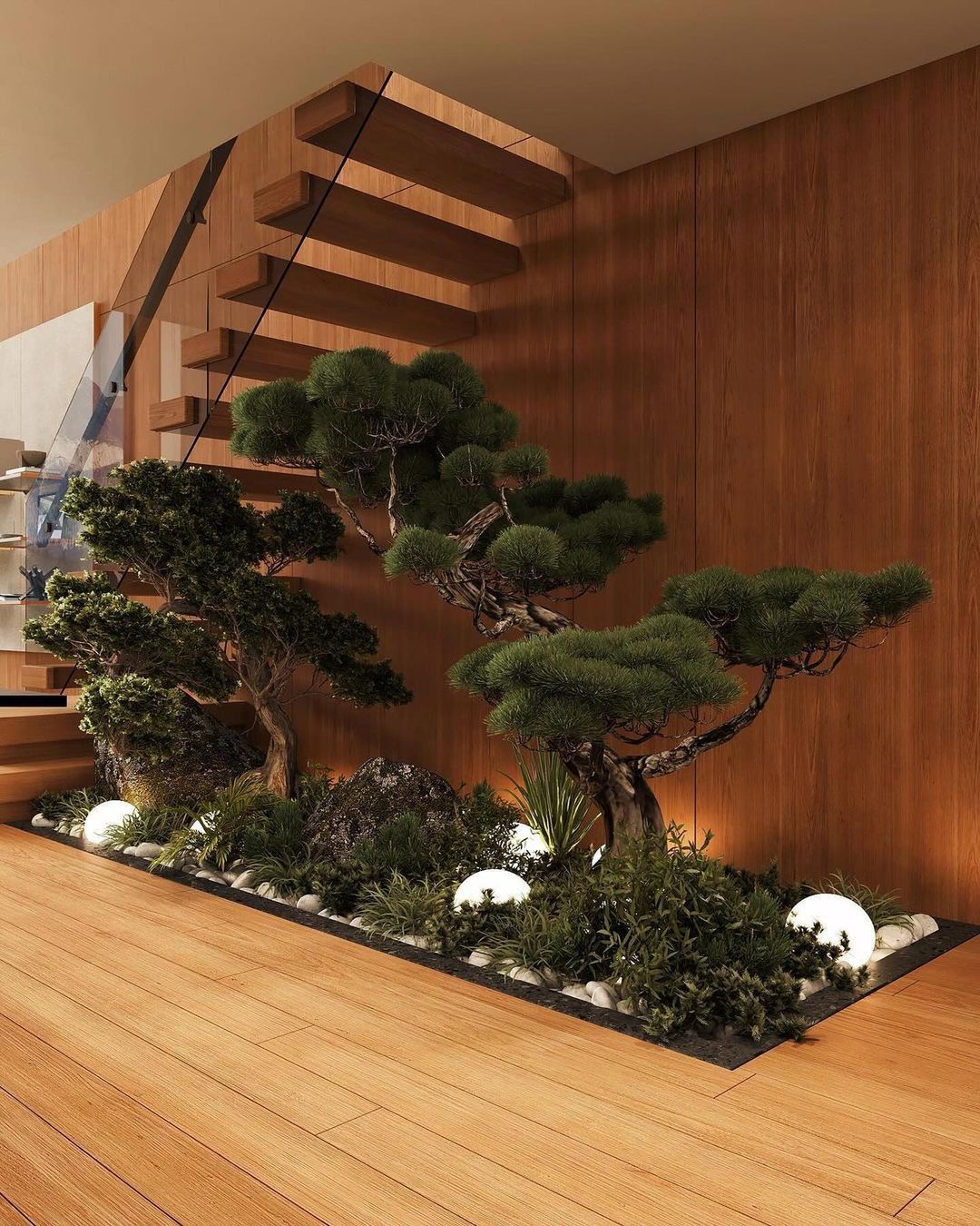 A serene indoor garden placed under a floating wooden staircase