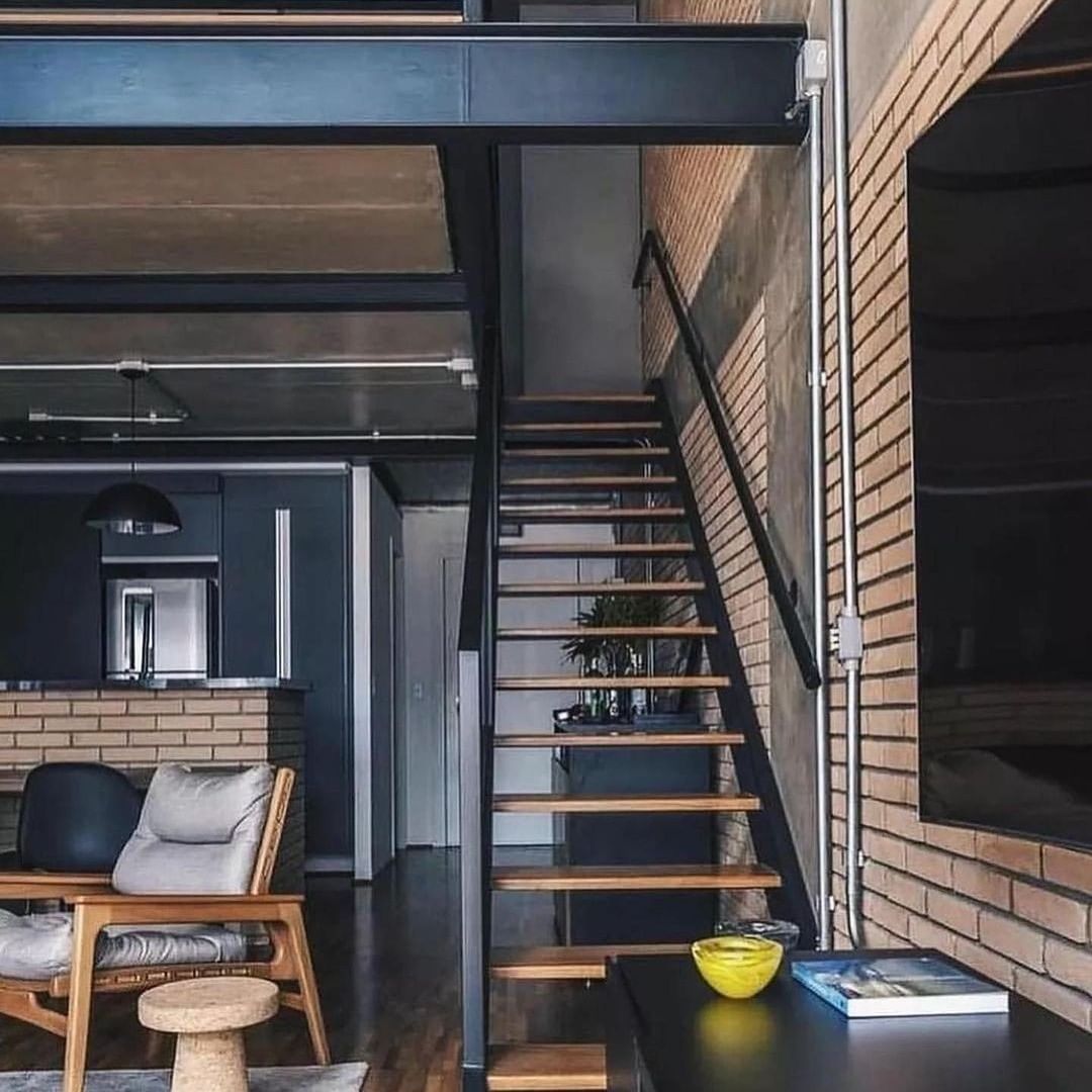 Modern industrial loft space with open staircase