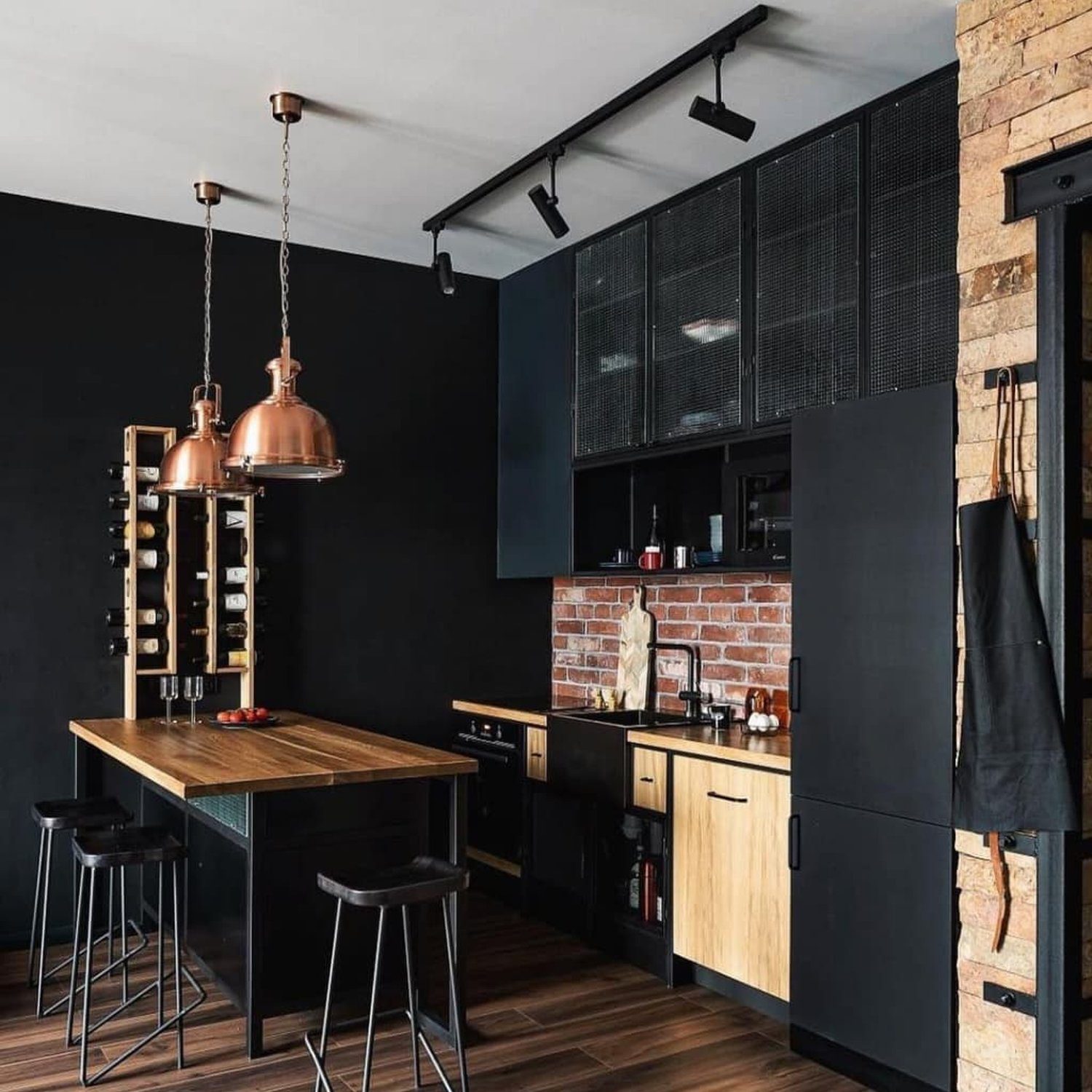 A modern industrial kitchen featuring dark tones and contrasting textures