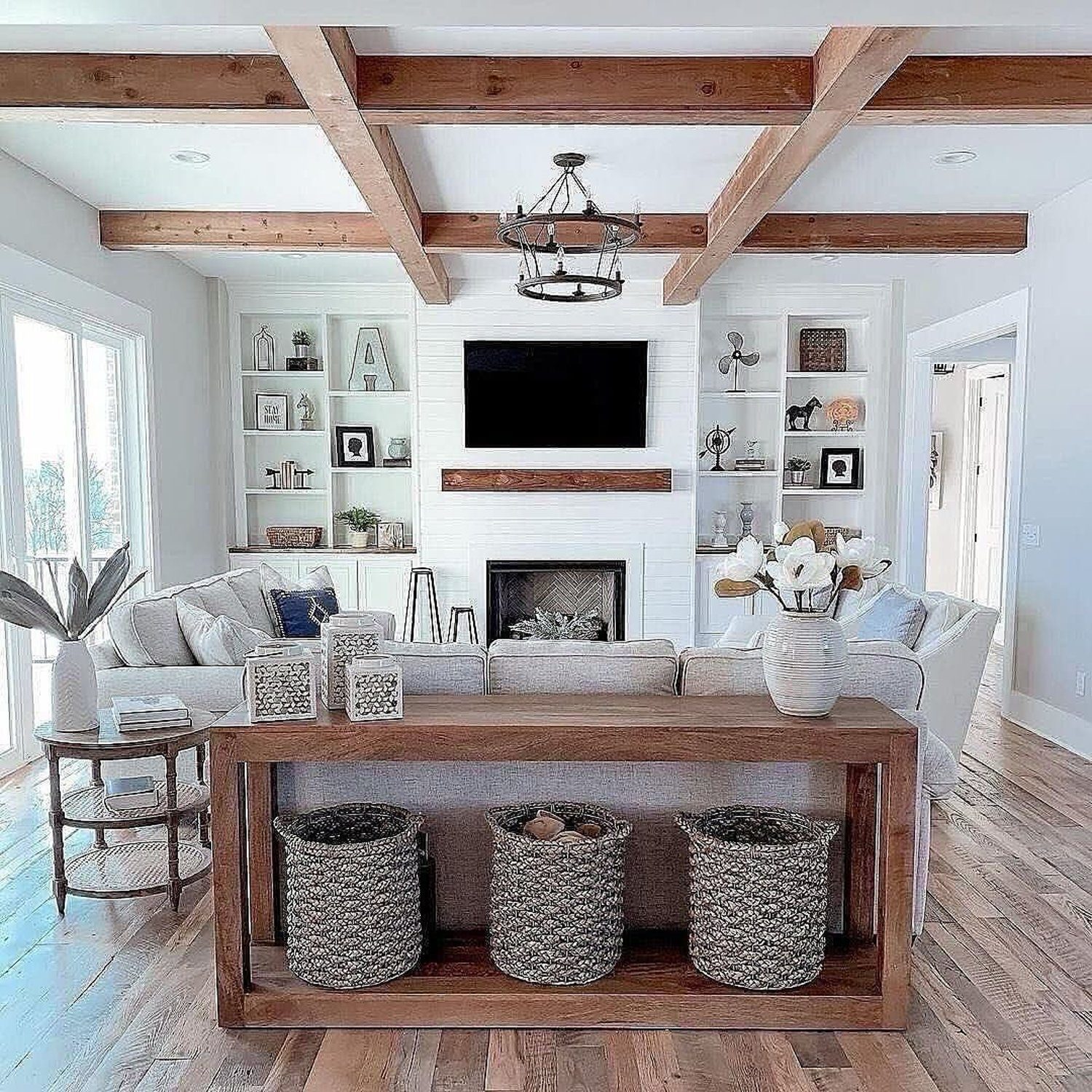 Elegantly designed living room with a cozy fireplace surrounded by built-in shelving