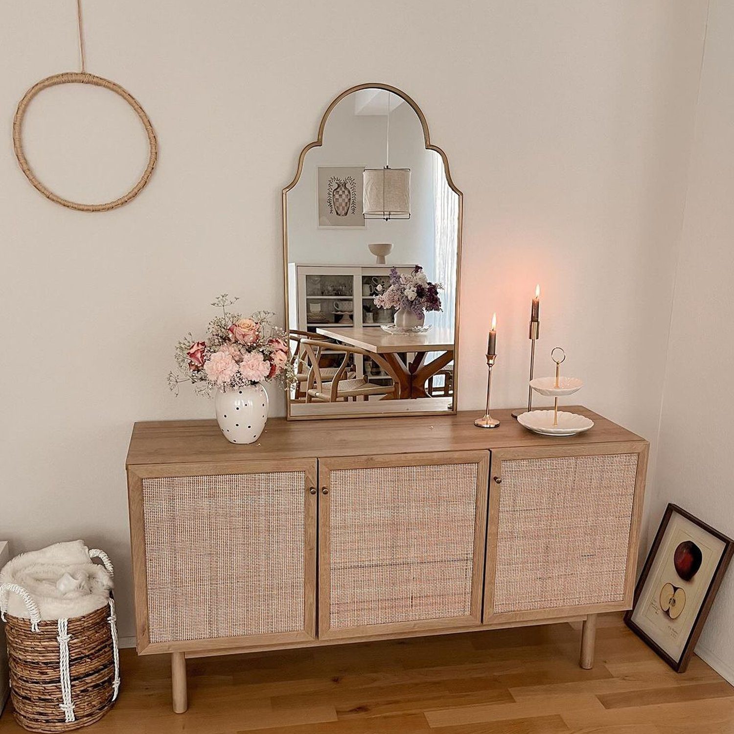 A neatly arranged living space with a wooden sideboard and textured cabinet doors