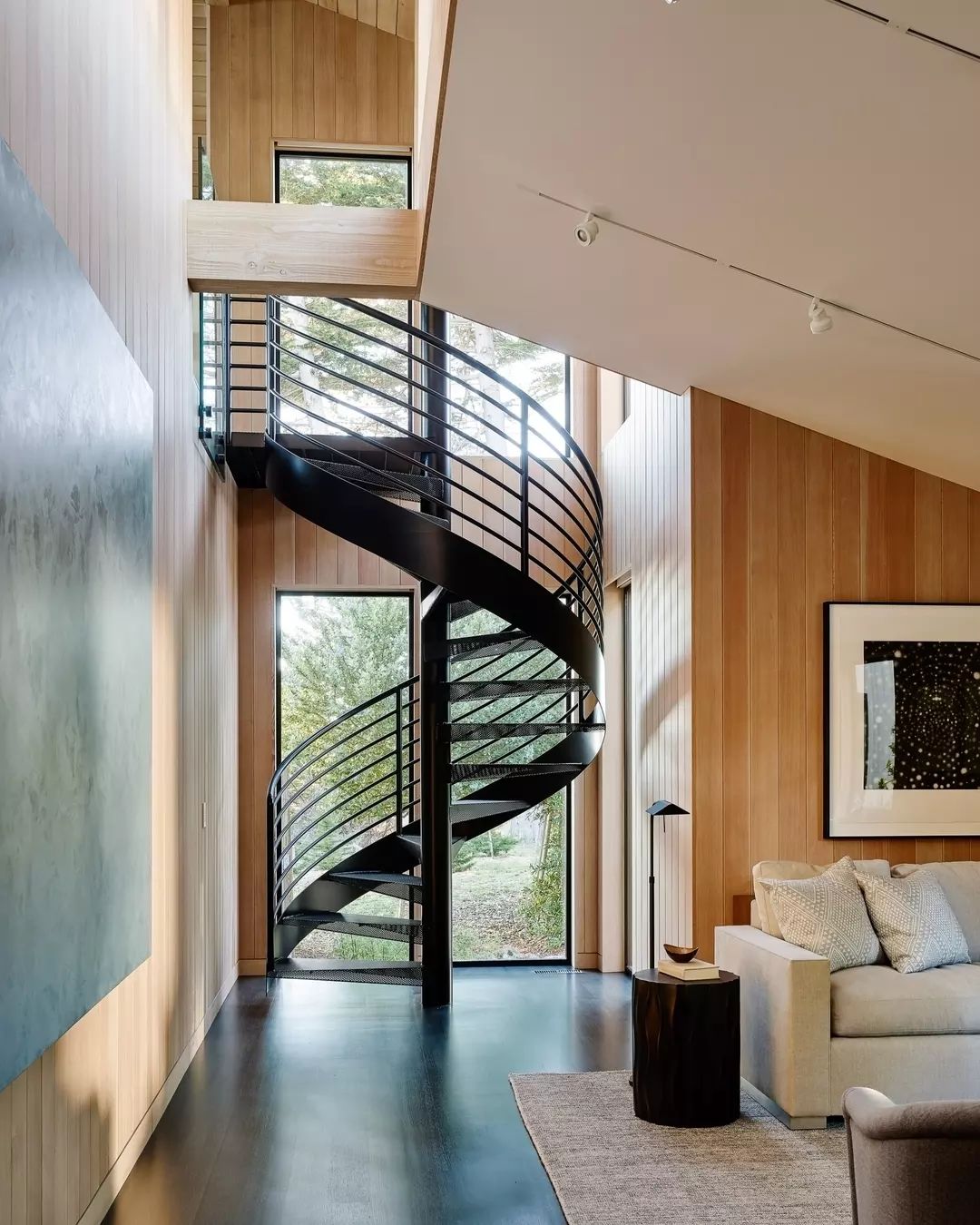 A modern interior showcasing a sleek black spiral staircase