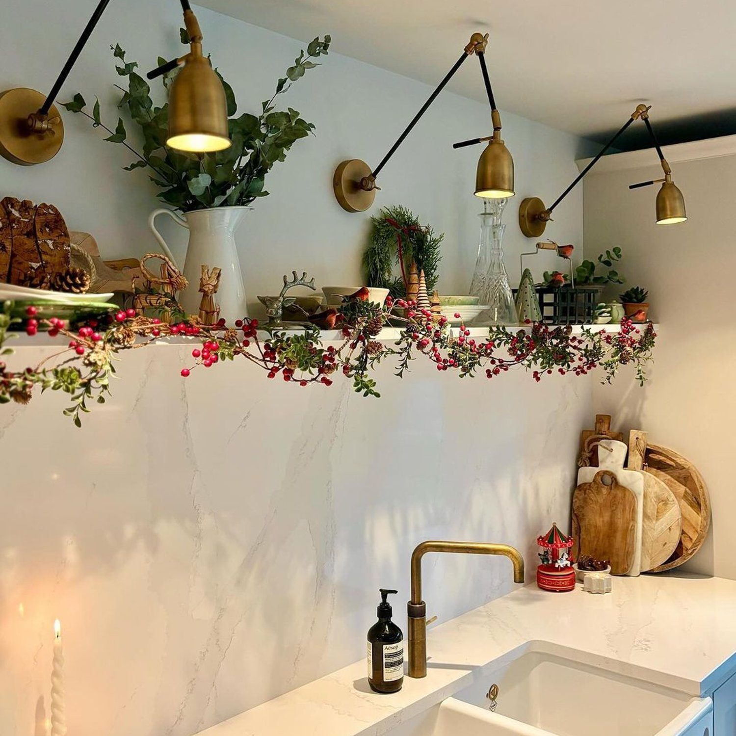 A quaint kitchen corner featuring festive decorations and sleek modern fixtures