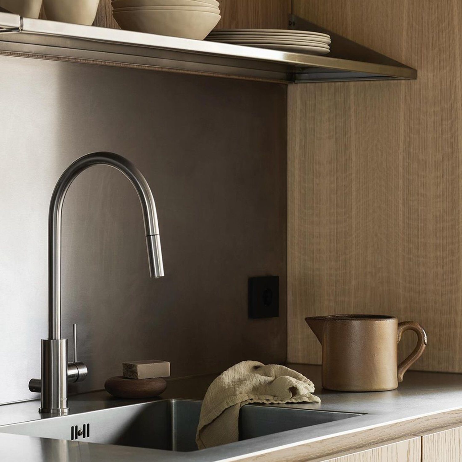 Modern and sleek kitchen design featuring wooden cabinetry and a stone countertop