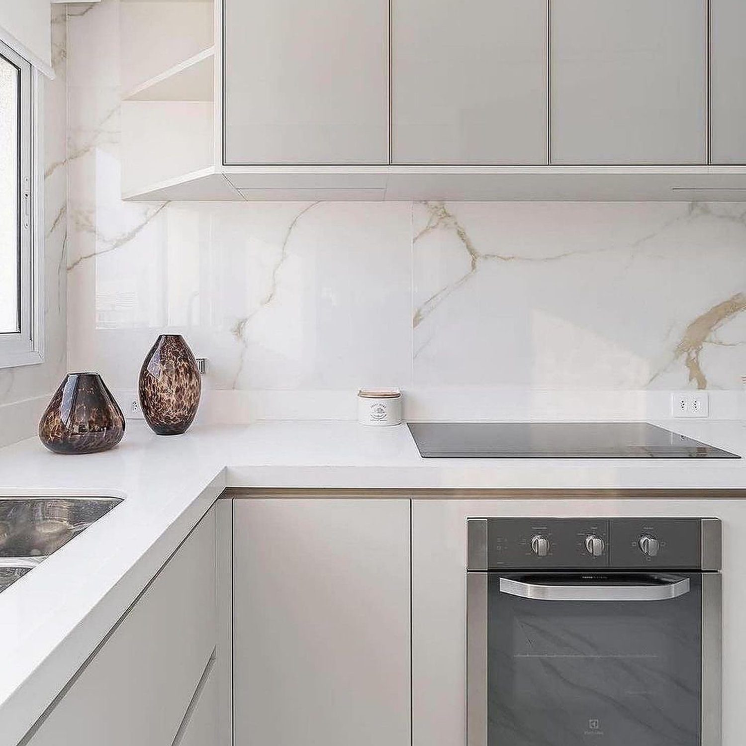 Elegant minimalist kitchen with marble backsplash