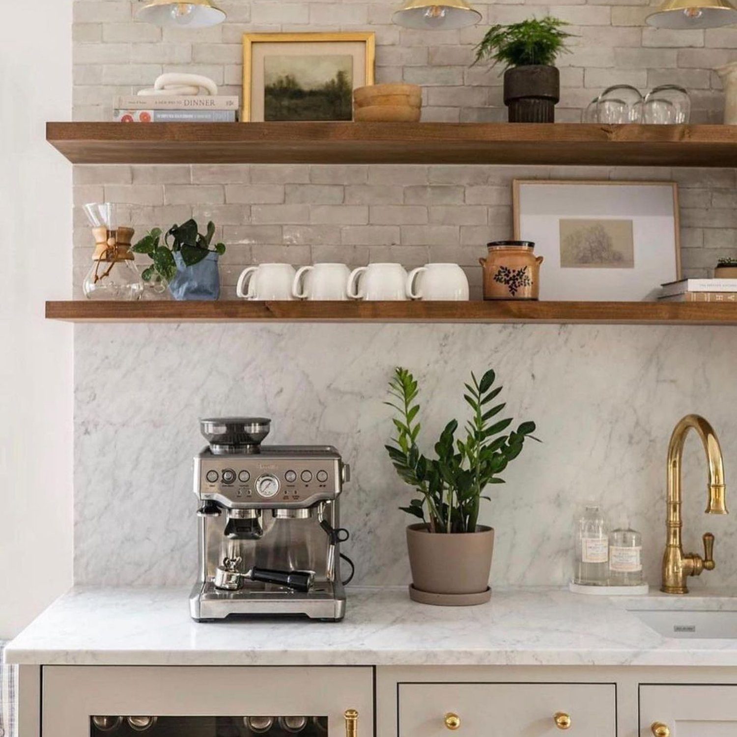 A chic kitchen corner featuring an espresso machine and marble countertops