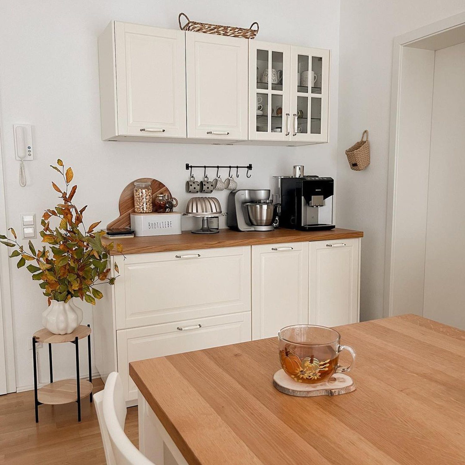 A neatly organized kitchen with wooden countertops