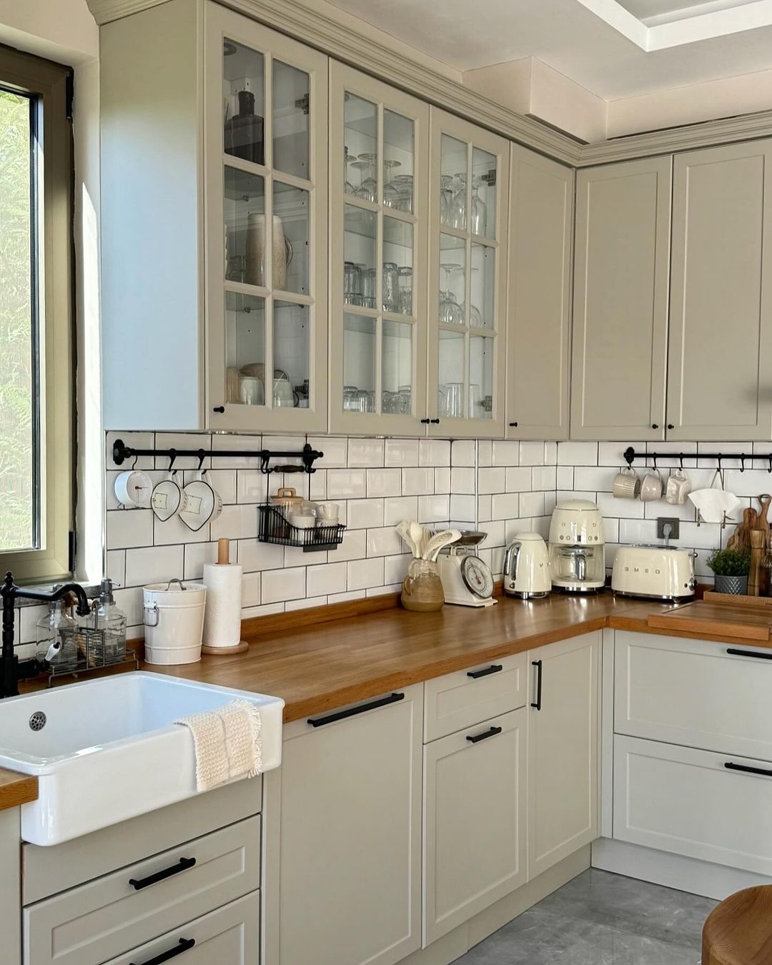 A modern kitchen with wooden countertops and white cabinetry