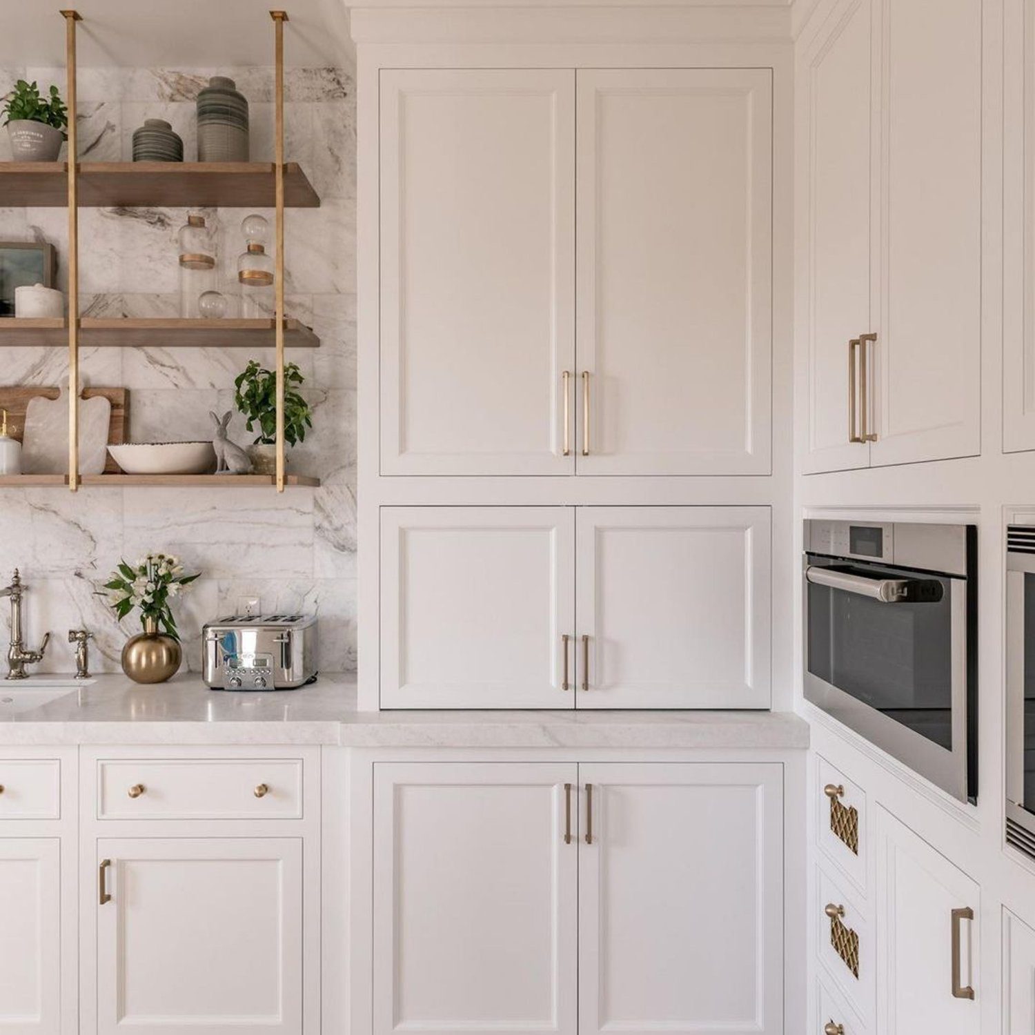 Elegant white kitchen with marble countertops