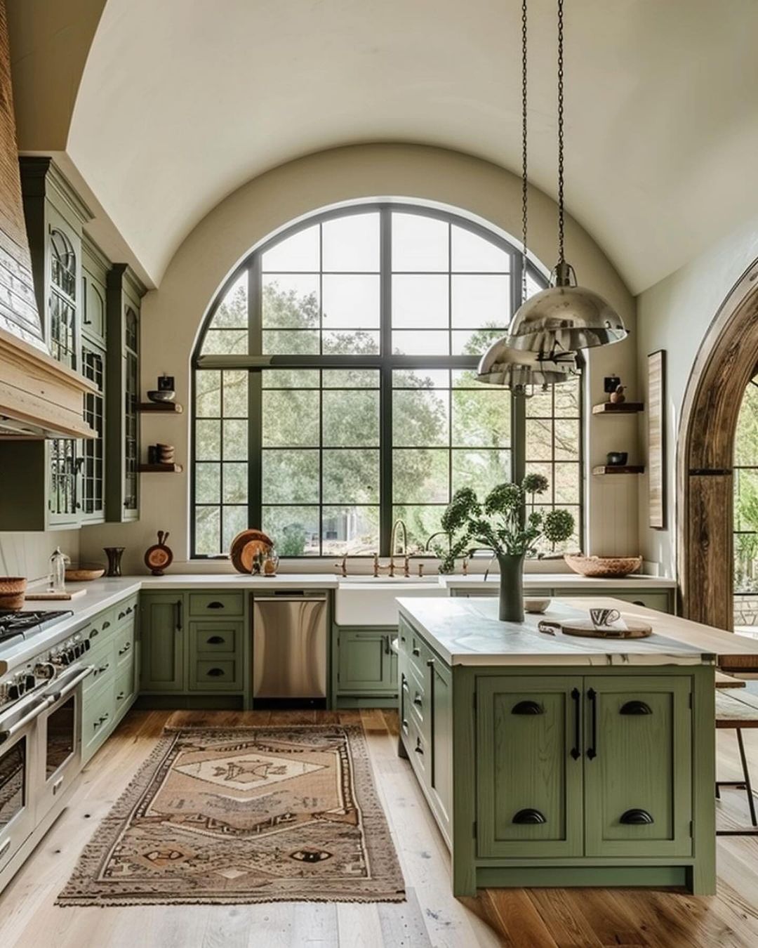 A spacious kitchen with an arched window