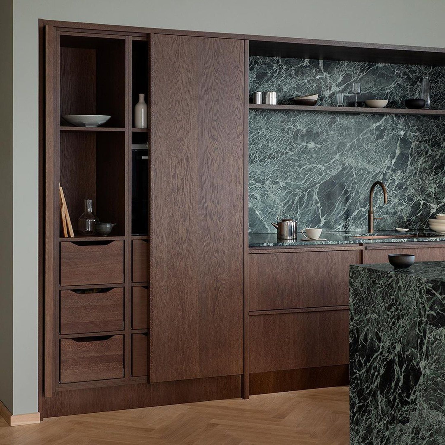 Elegant kitchen with dark wood cabinetry and green marble backsplash