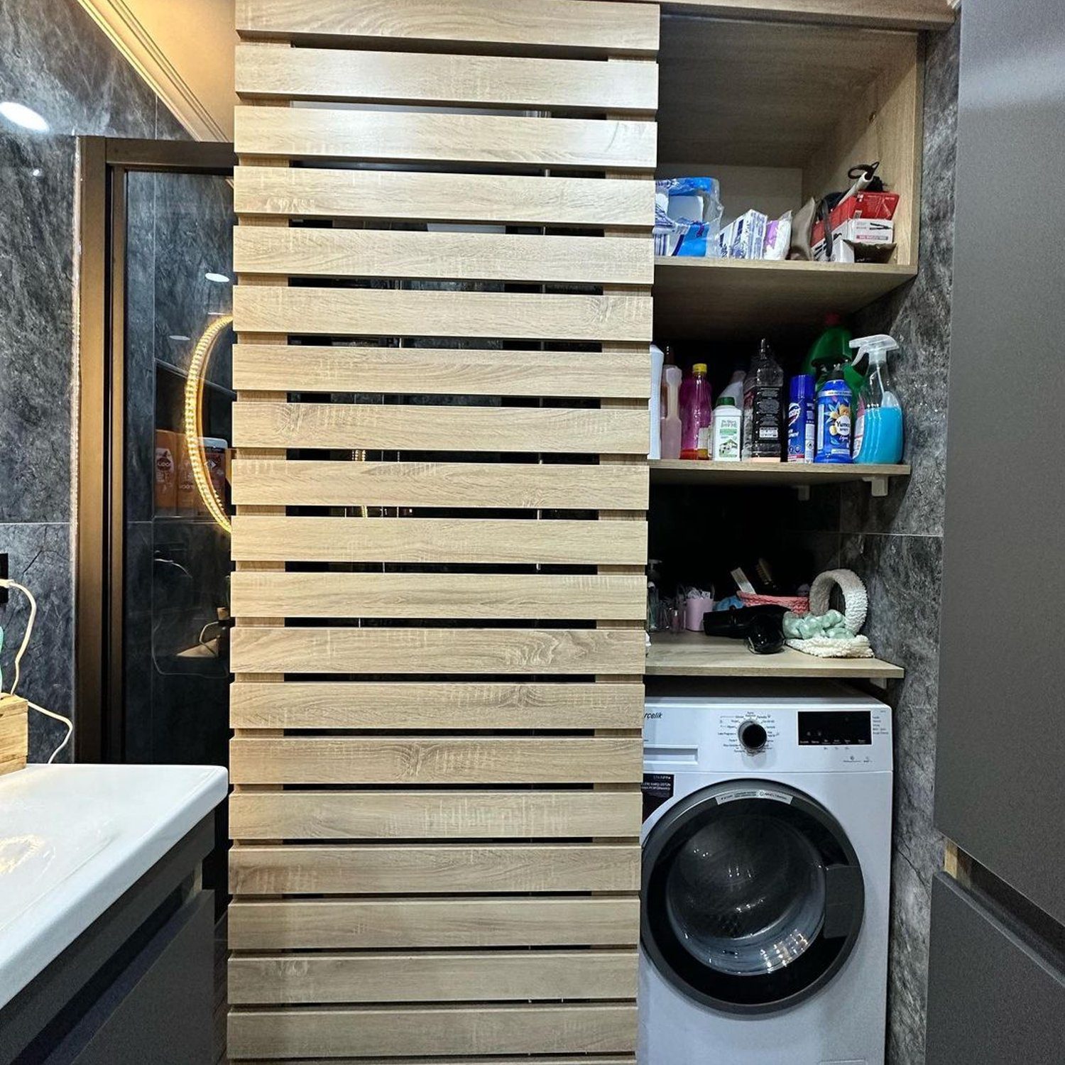 A functional and aesthetically pleasing laundry area with a hidden washing machine