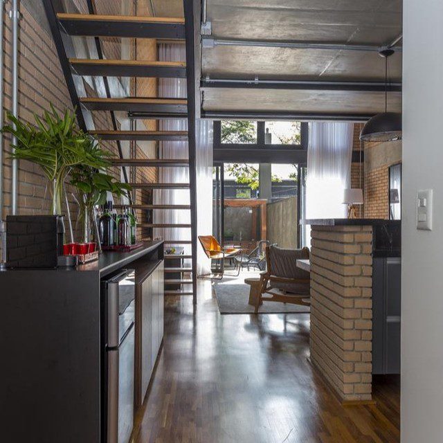 Loft-style apartment kitchen with exposed brick and metal accents