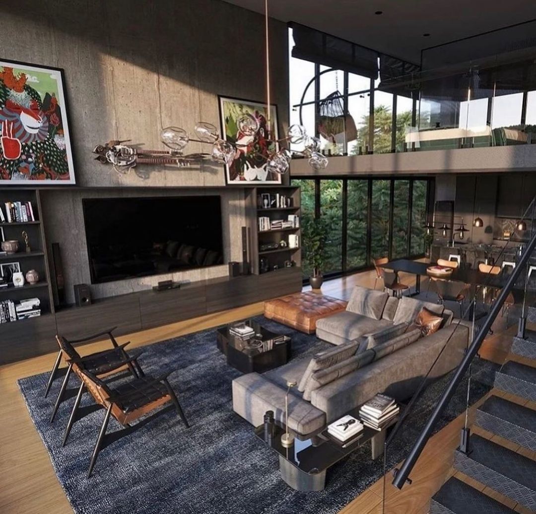 A modern loft-style living room with concrete walls and full-height windows