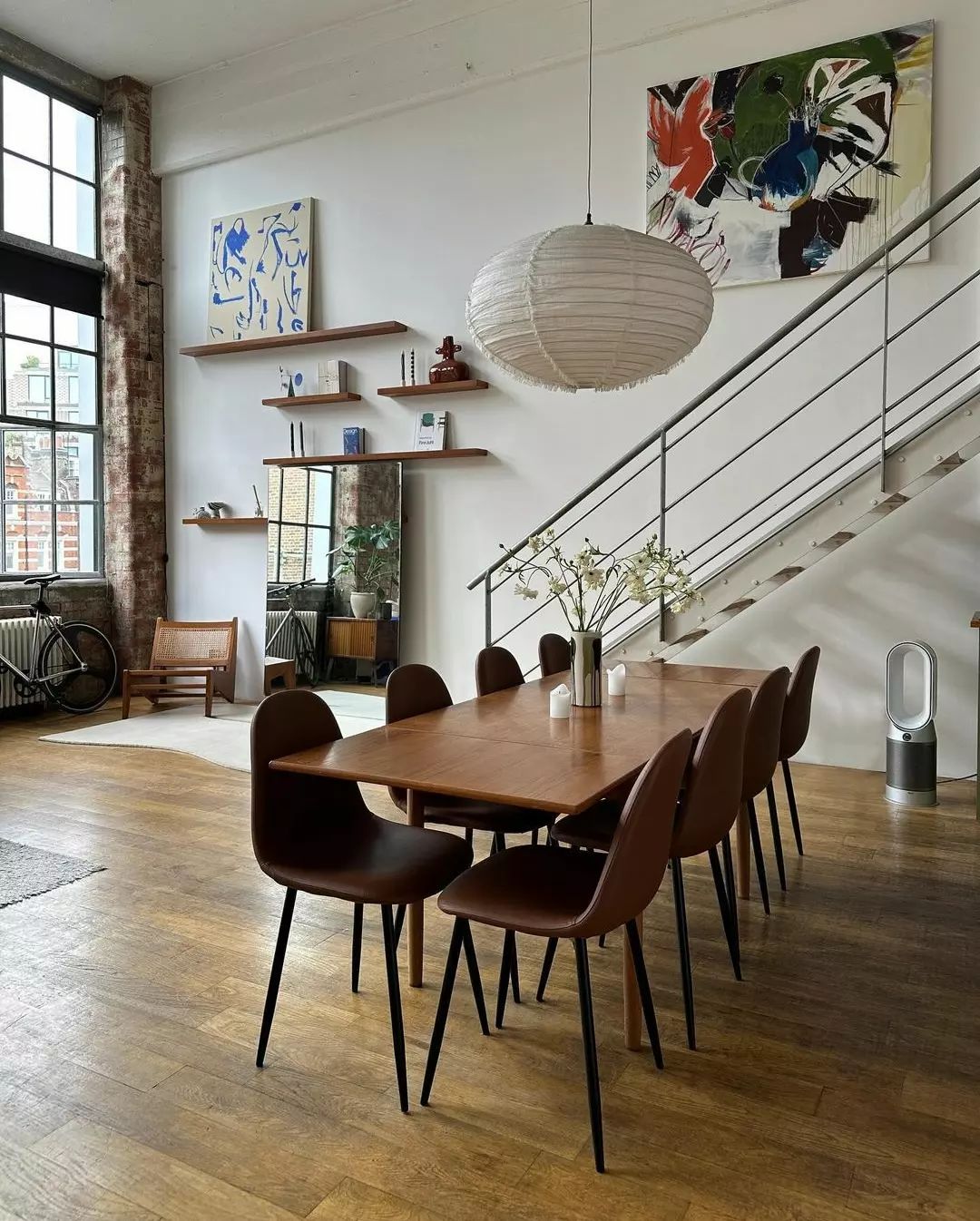 A tastefully designed loft dining area with exposed brick and modern furnishings