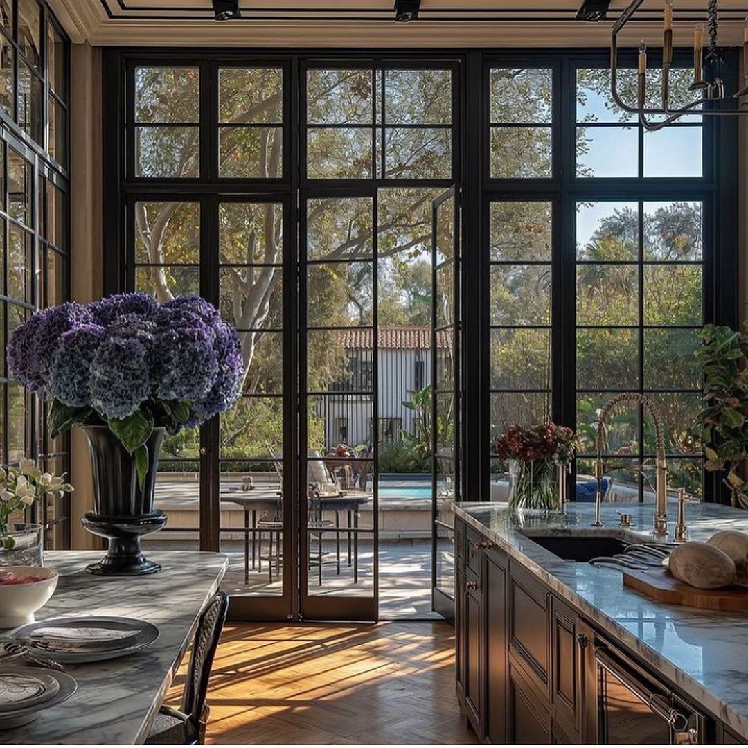 A luxurious kitchen with floor-to-ceiling windows