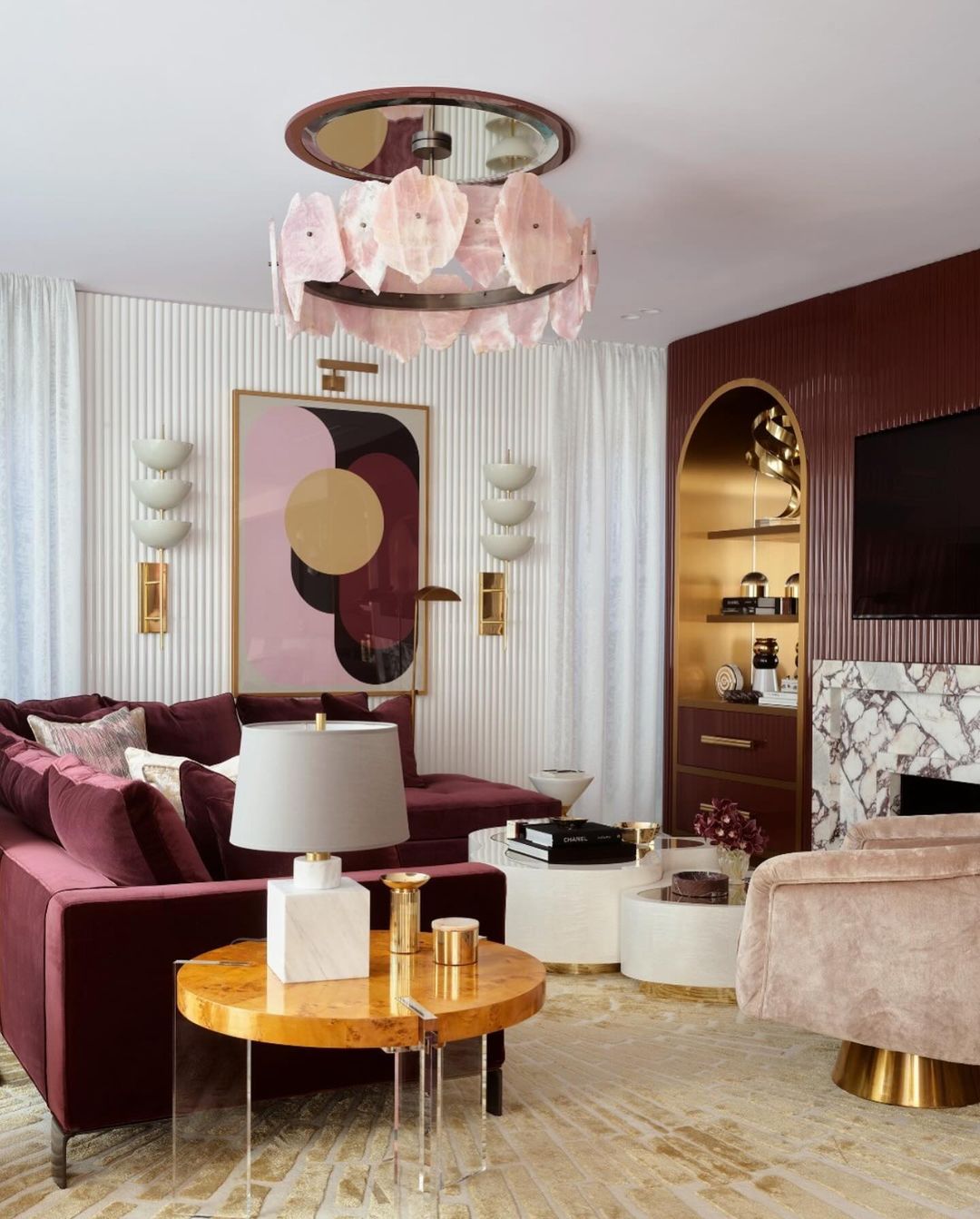 A luxuriously appointed living room in rich maroon and gold hues