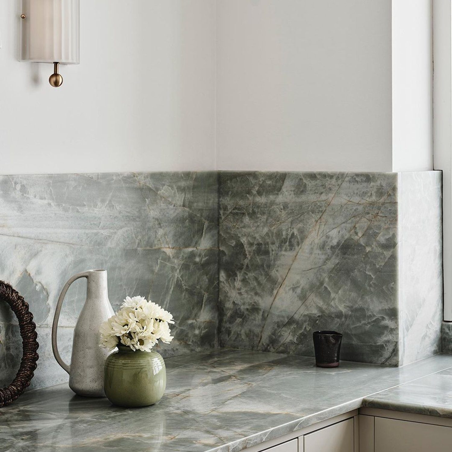 Elegant kitchen featuring a marble backsplash