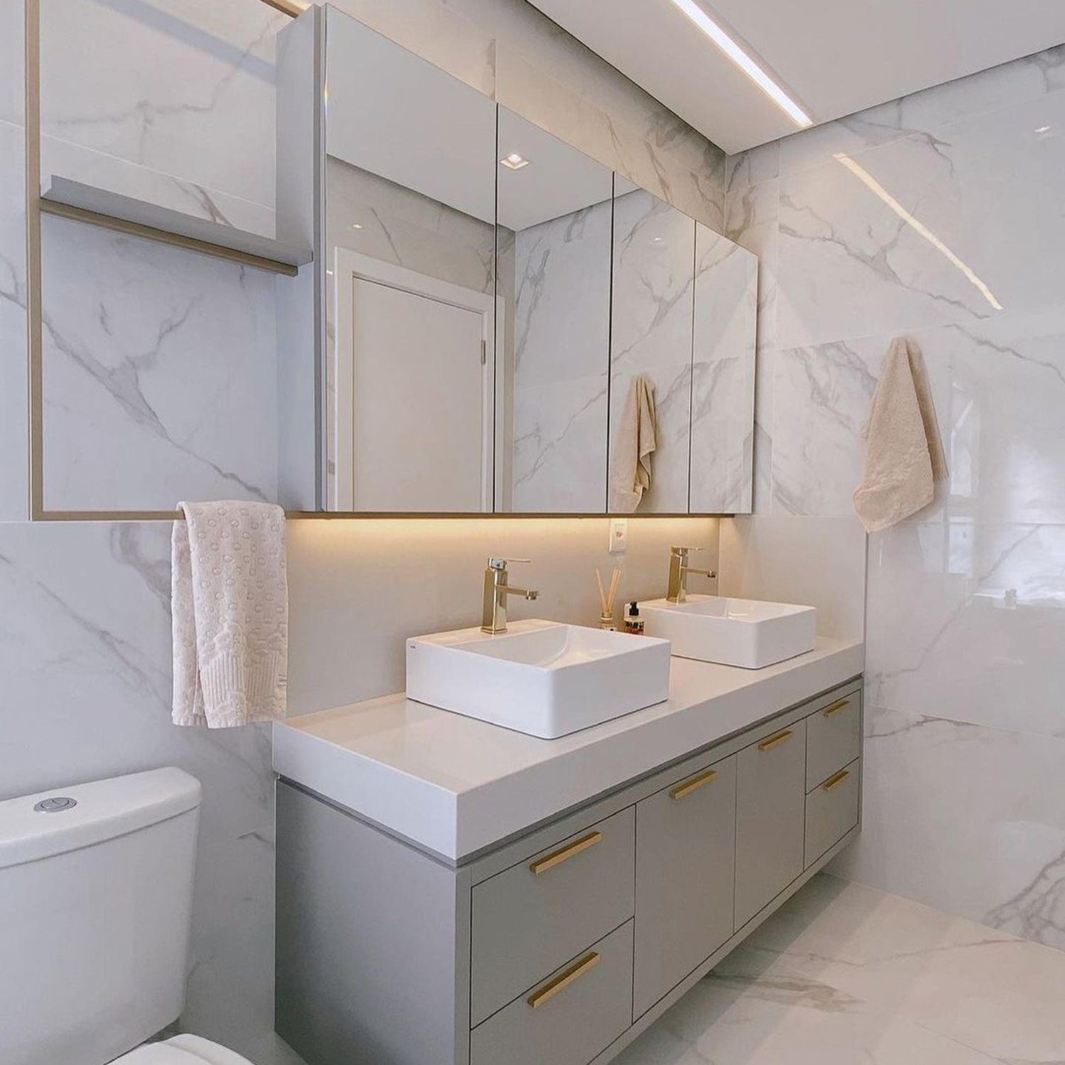 Elegant marble bathroom featuring twin rectangular vessel sinks