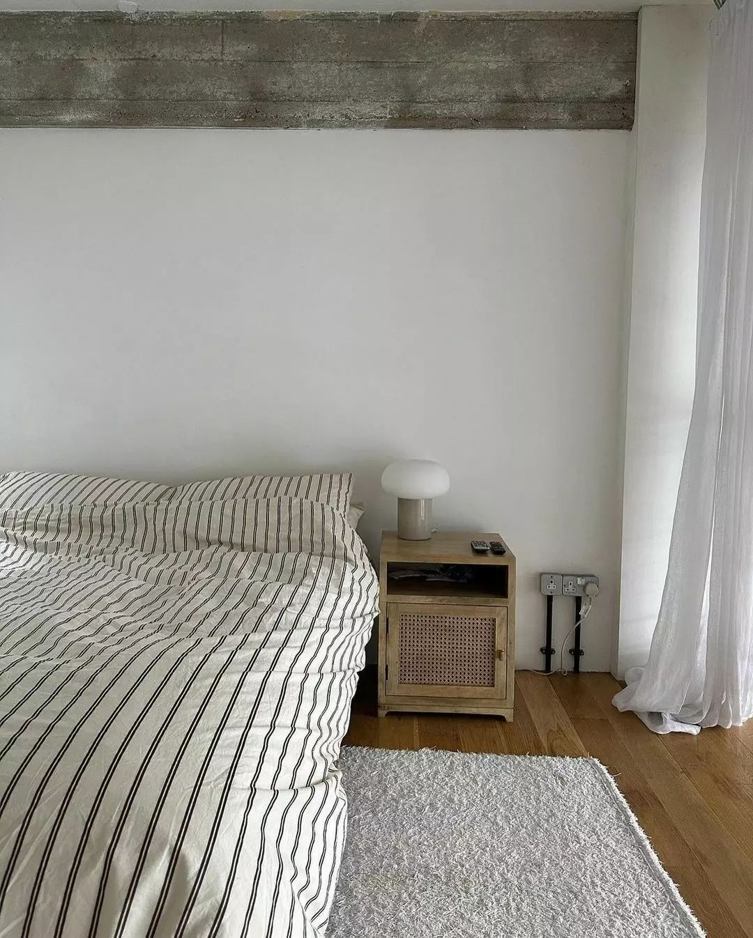 Minimalist Bedroom with Concrete and Wood Elements