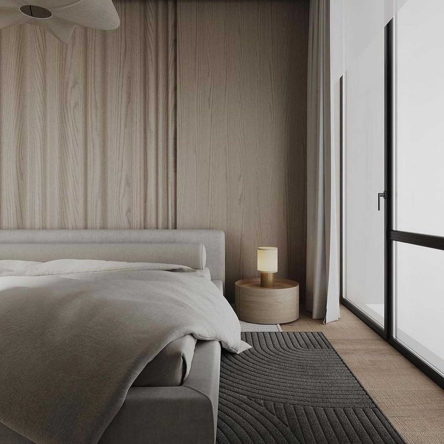 A minimalist bedroom featuring wooden wall paneling, a plush grey bed with neutral bedding, and a sleek bedside lamp.