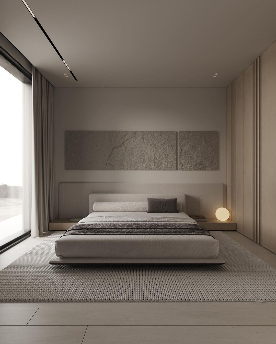 A minimalist bedroom design featuring a low-profile platform bed and earth-toned accents.