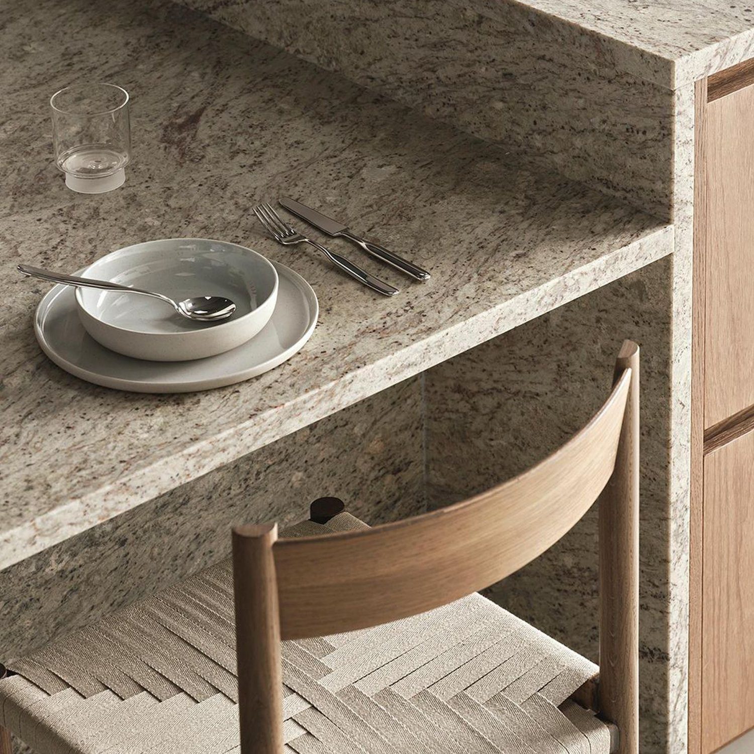 Elegantly simple dining setup featuring a textured granite countertop