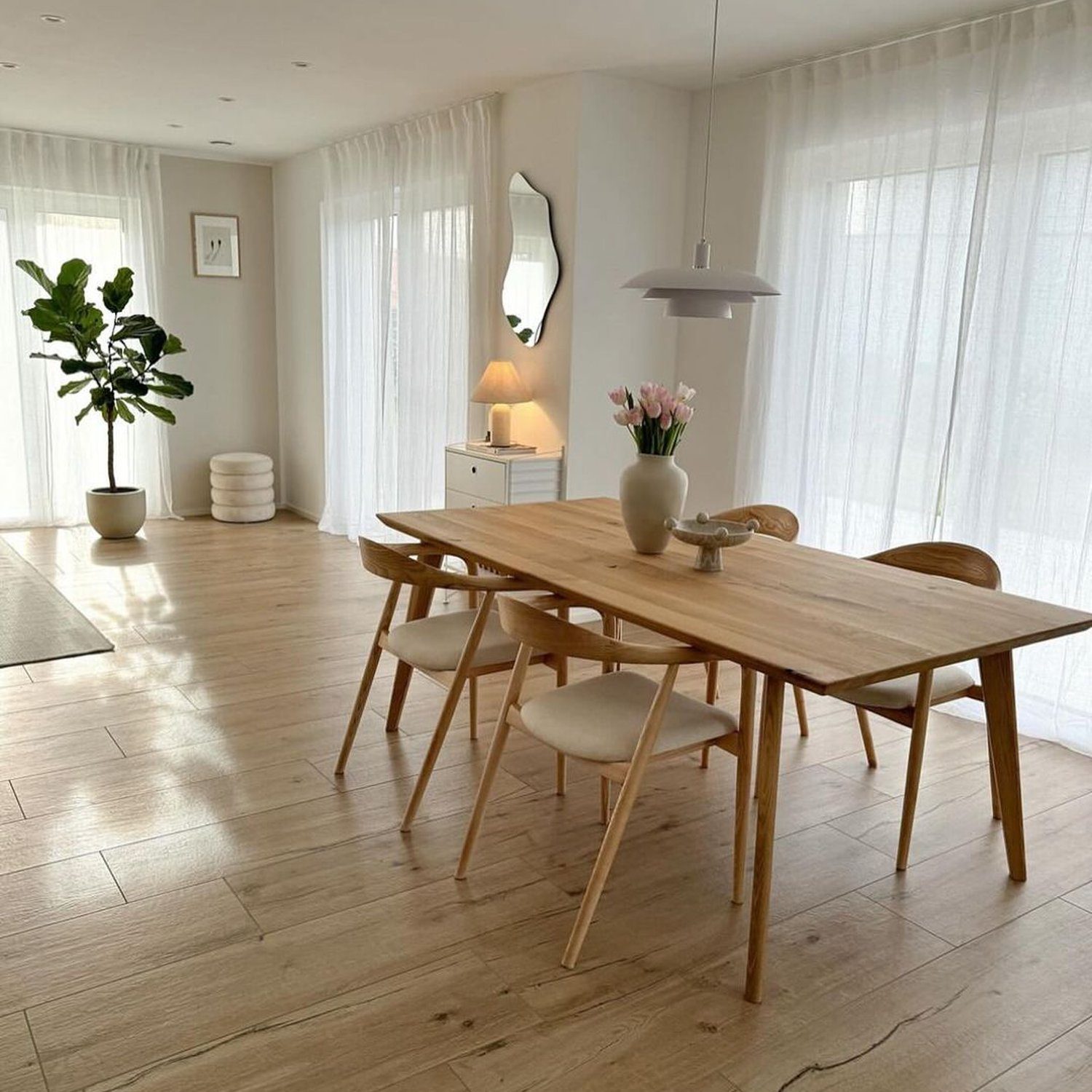 A minimalist dining room with natural light