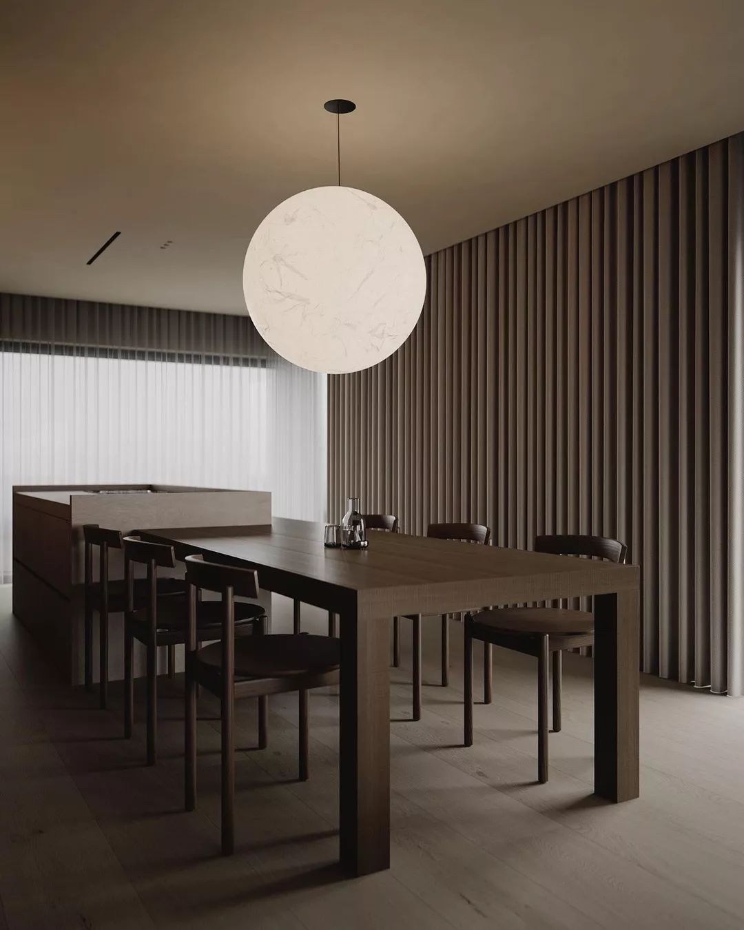 A minimalist dining room with clean lines and a striking spherical pendant light