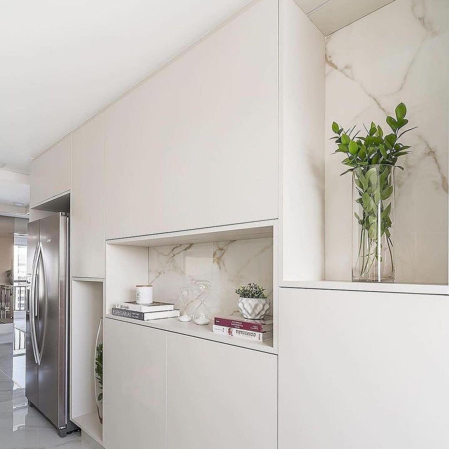 Elegant minimalist kitchen design featuring a seamless cabinetry with marble accents