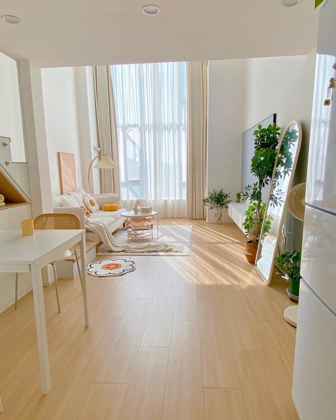 A bright and airy minimalist living room with large windows and modern furniture.