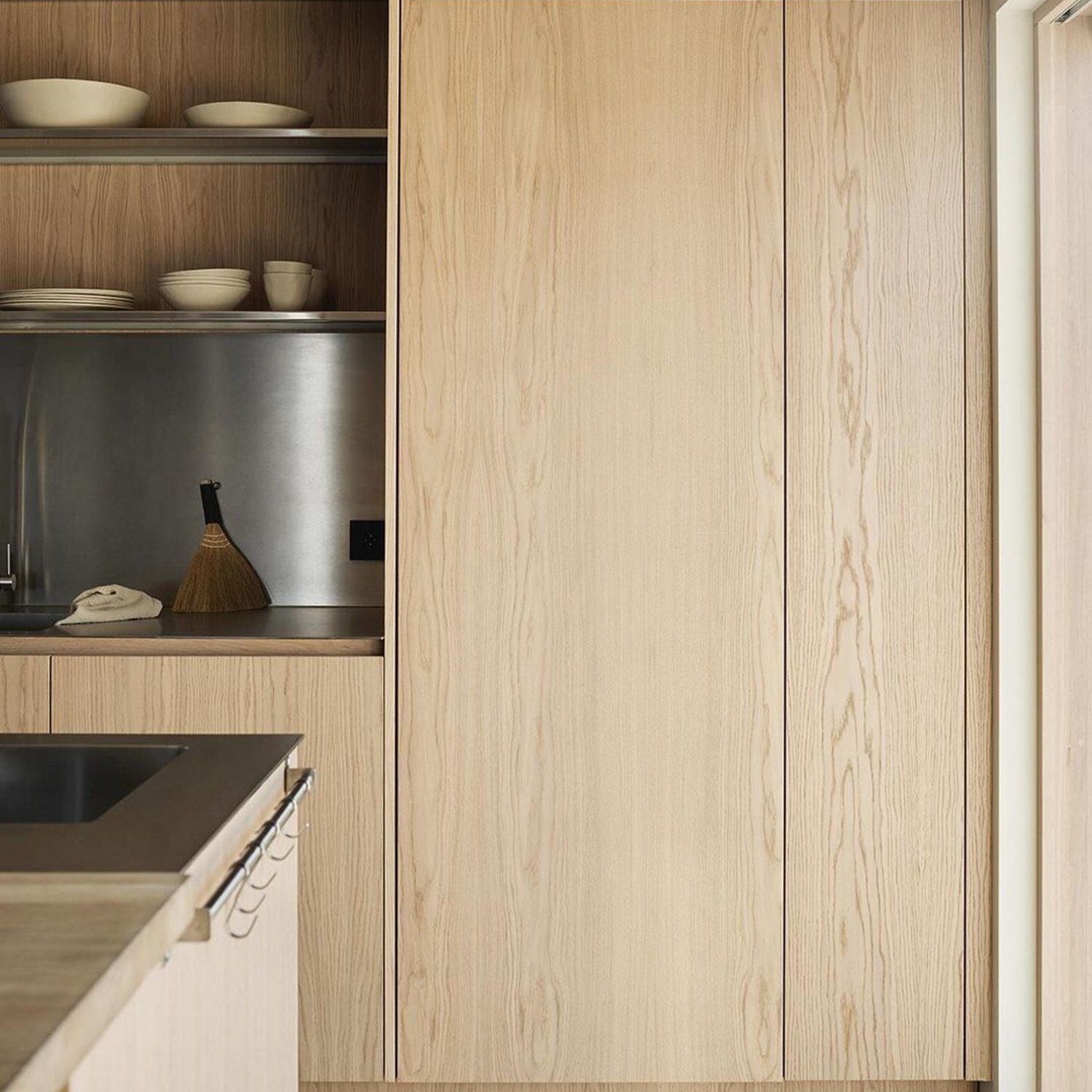 A minimalist kitchen with seamless wood cabinetry