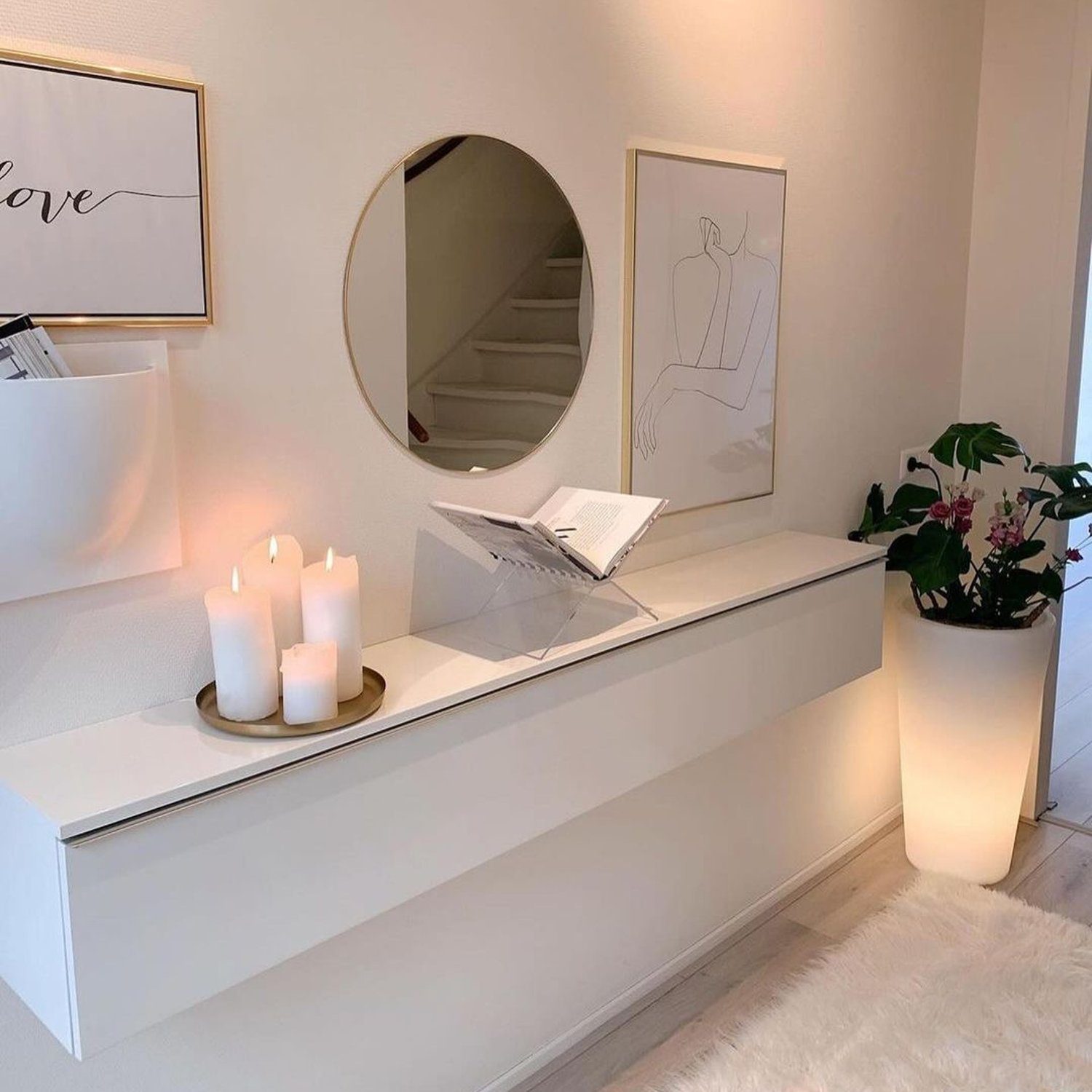 A minimalistic entryway featuring a sleek white console table