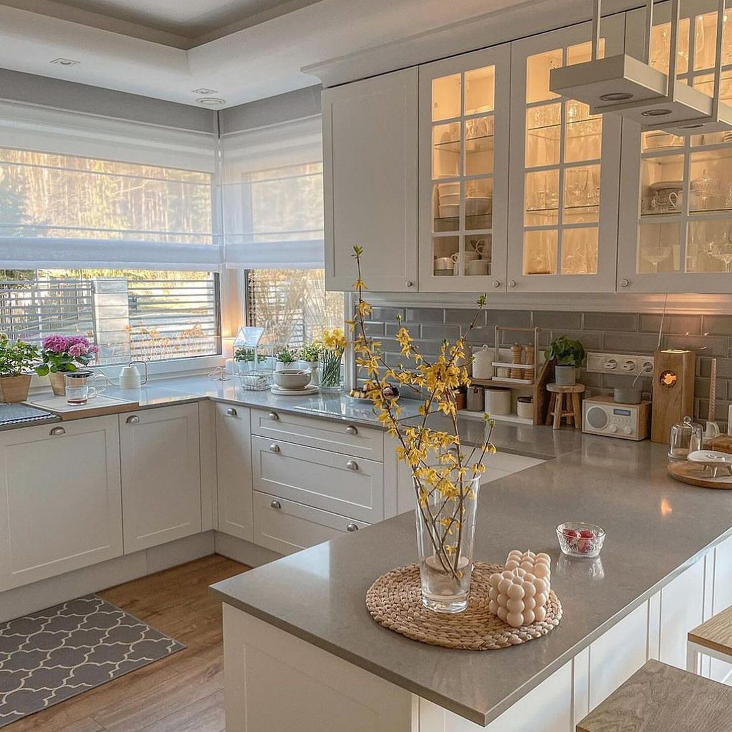 A warm and inviting kitchen space with sunlight filtering in through the blinds