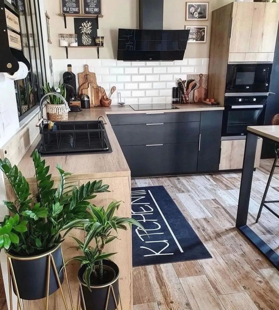 A modern kitchen with contrasting black cabinets and natural wood elements.