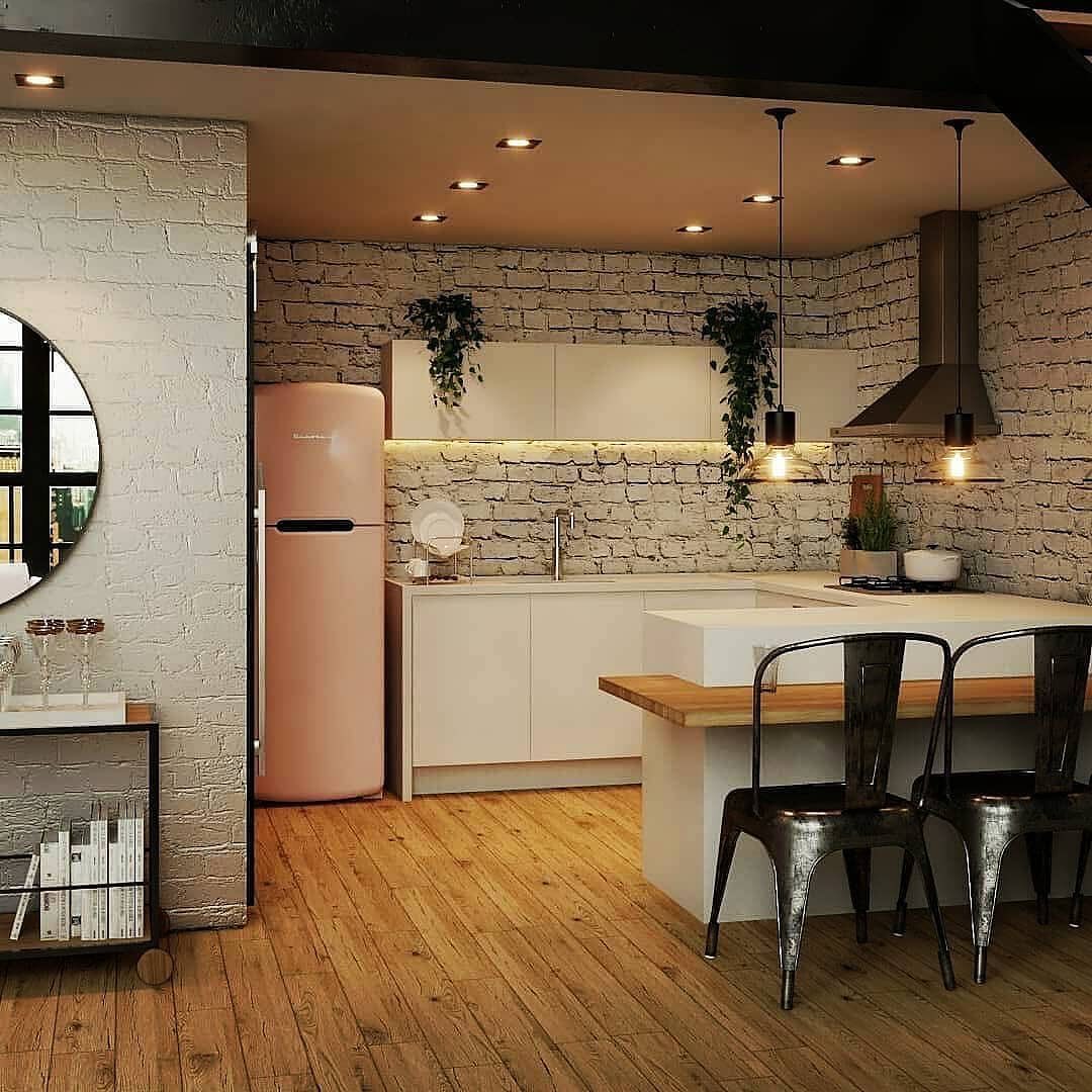 A chic modern kitchen with exposed white brick walls, a central island, and industrial-style black chairs.