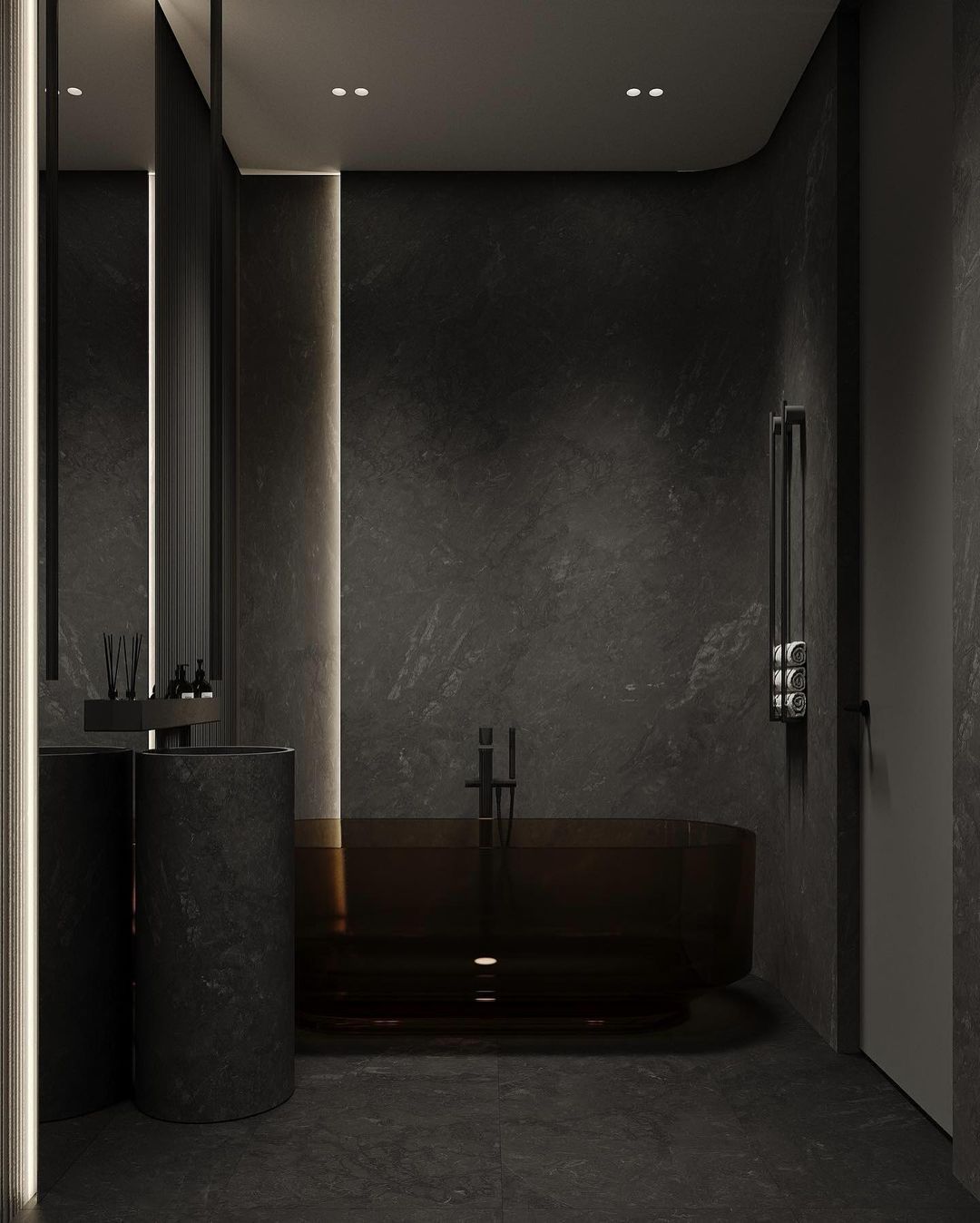 A modern and minimalist dark grey bathroom featuring a sleek, circular free-standing bathtub and wall-mounted fixtures