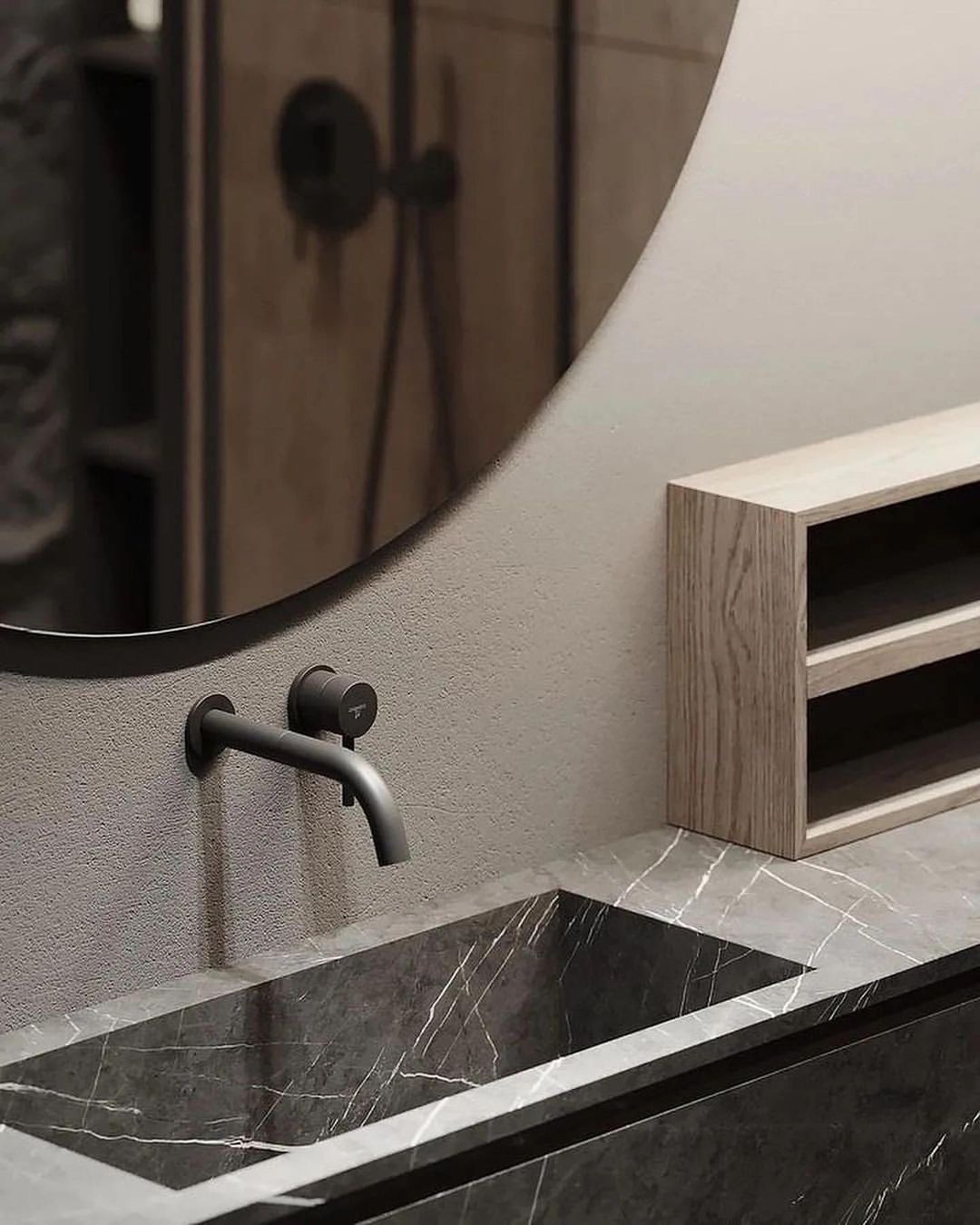 A minimalist bathroom featuring a geometric stone sink, wall-mounted matte black faucet, and sleek wooden cabinetry.