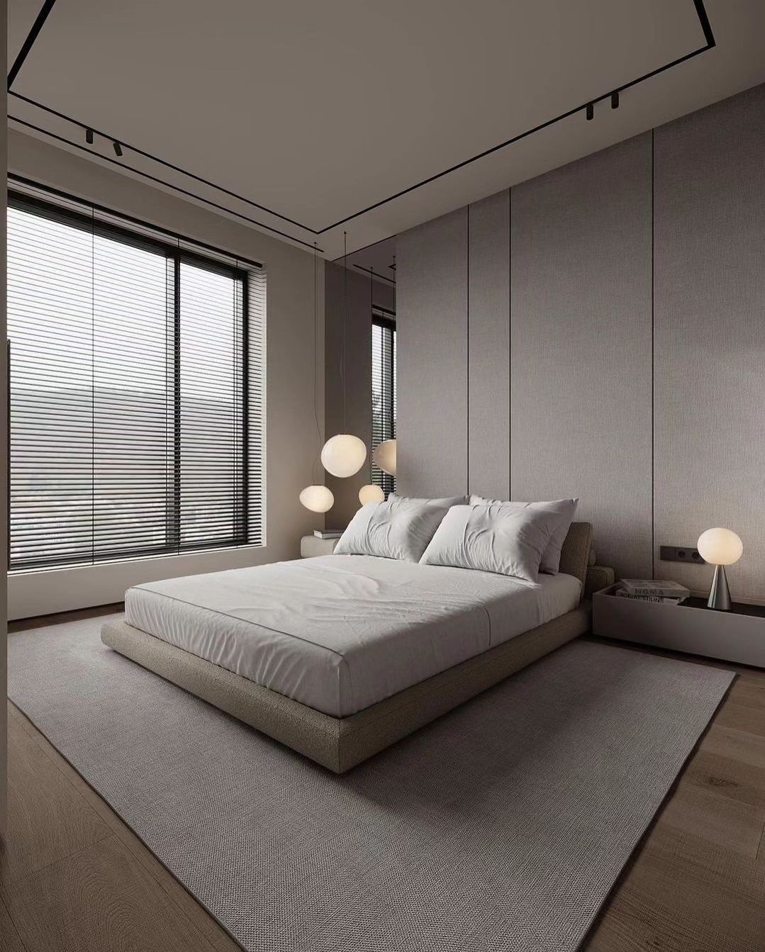 A minimalist bedroom featuring a large window with blinds, a platform bed with textured bedding, and spherical bedside lamps.