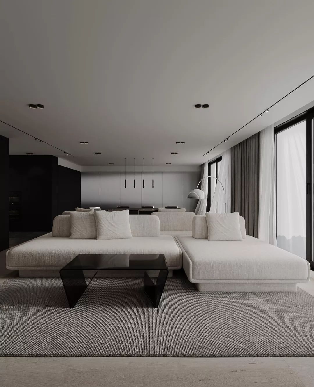 A modern minimalist living room featuring a sleek black kitchen in the background