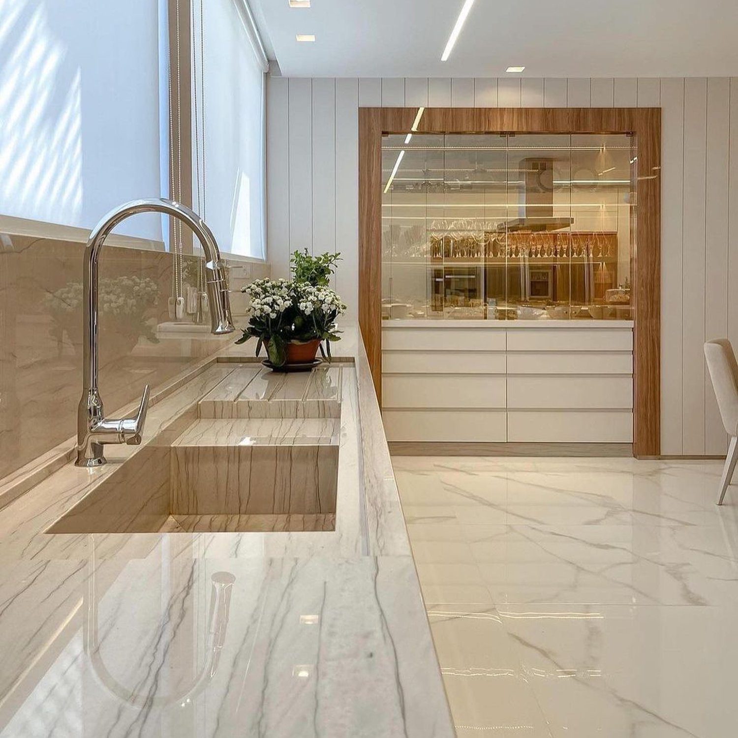 Elegant kitchen design featuring high-gloss marble countertops