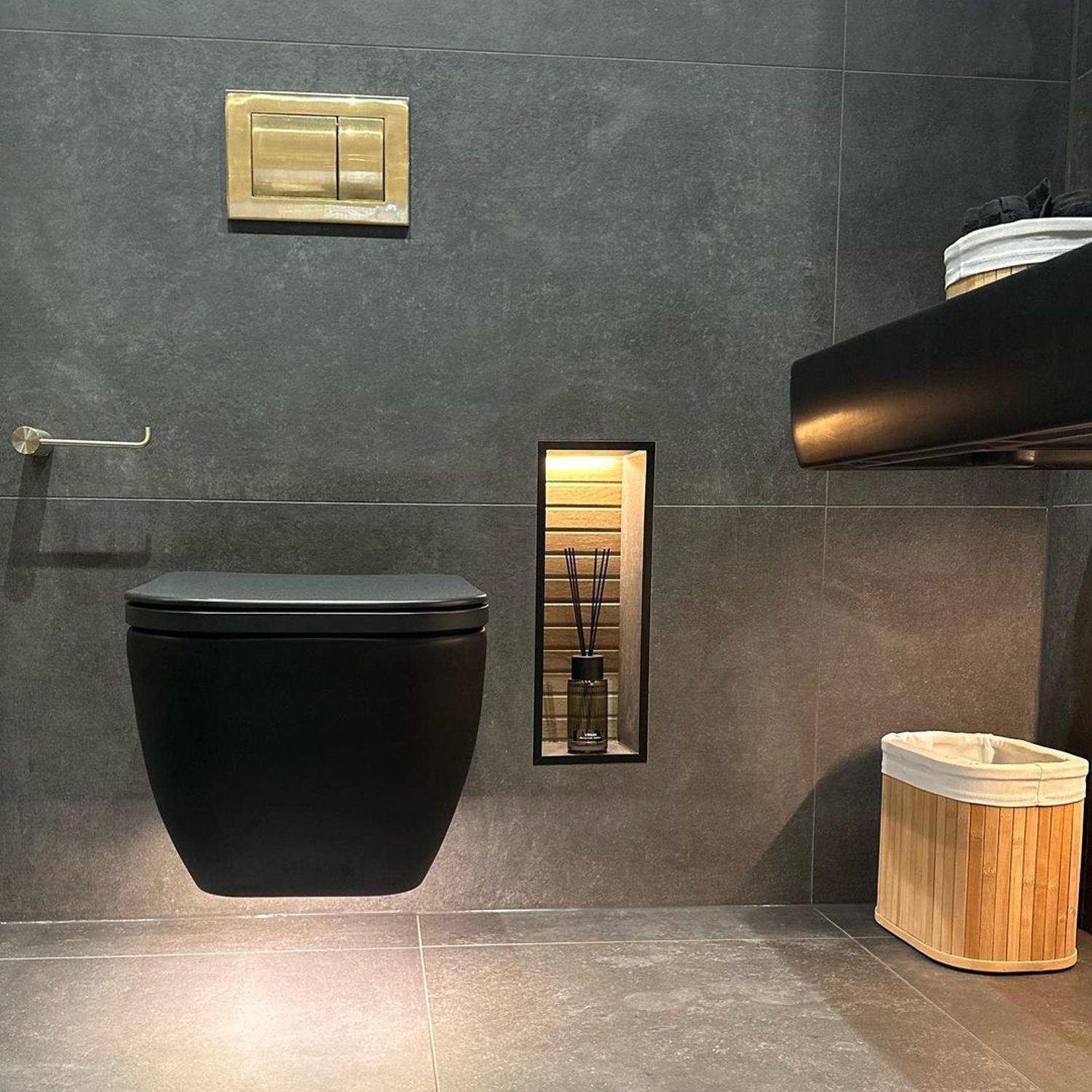 A modern bathroom with a sleek black toilet