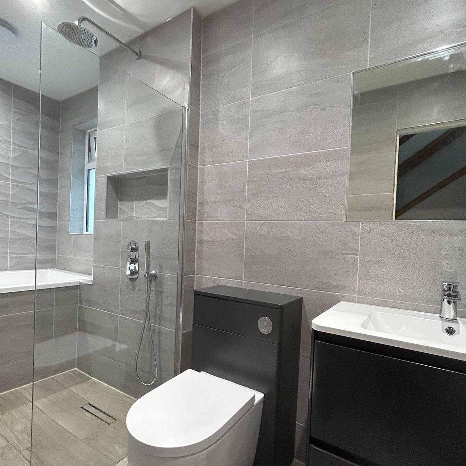 A modern, sleek bathroom with gray tiles