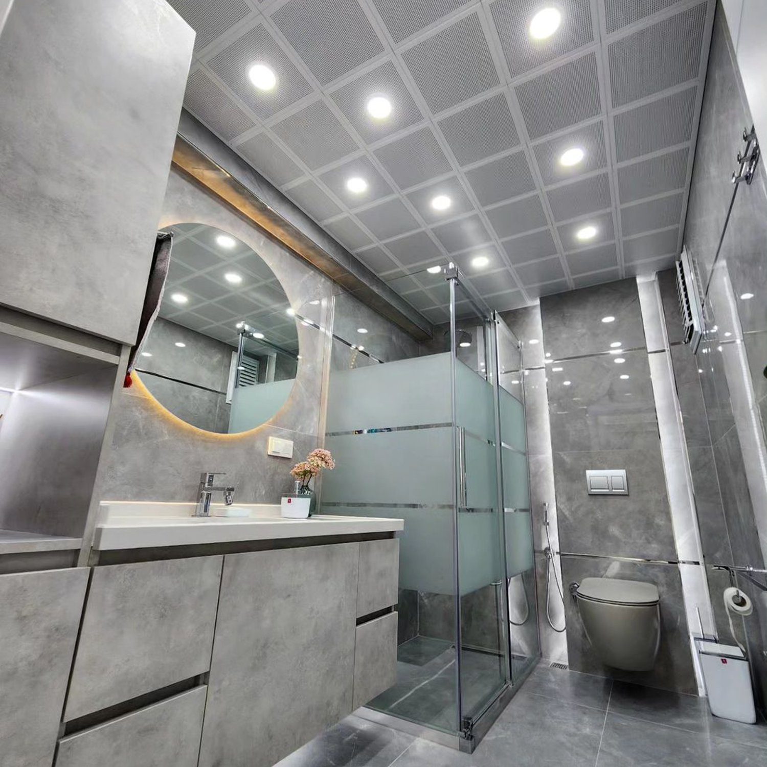 A modern and sleek bathroom design with gray tones and advanced fixtures