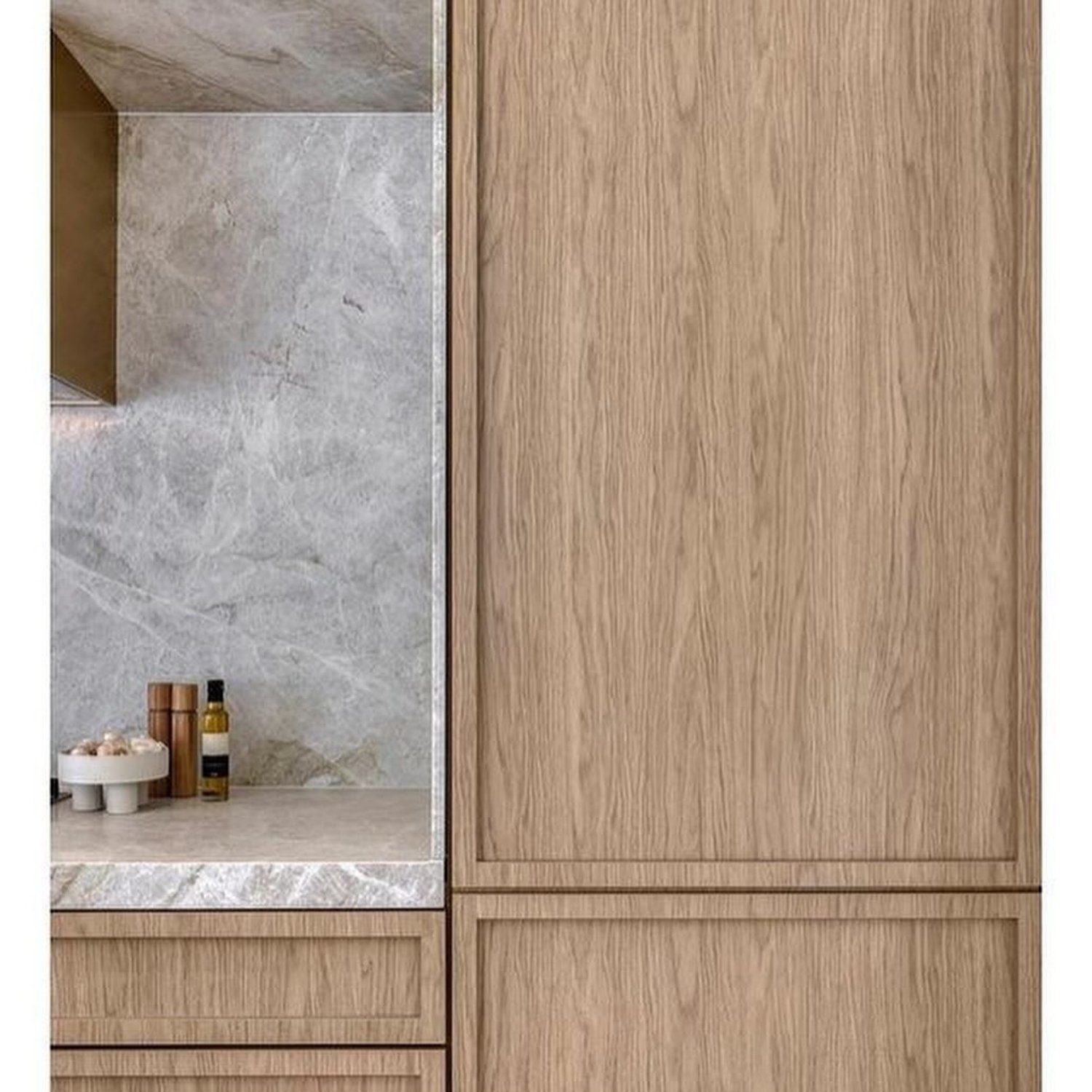 A sleek and modern bathroom cabinet design combining wood textures and marble patterns