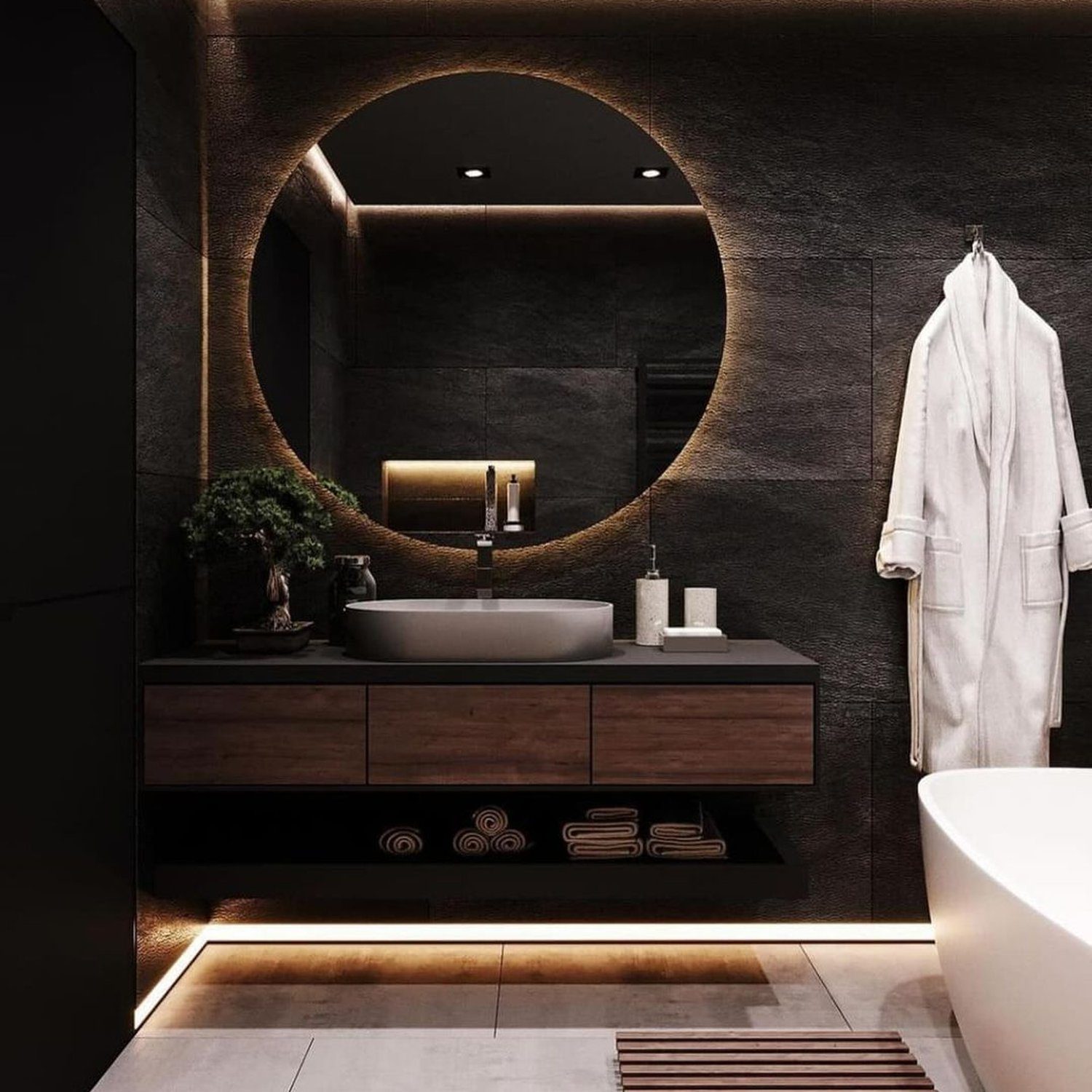 A chic and modern bathroom design featuring warm lighting and dark tones